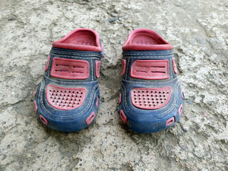 a dirty children footwear  put on a ground