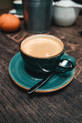green cup of coffee with spoon