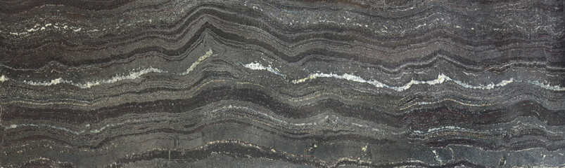 The rock is Jespilite. Layers and levels on the surface of gray stone