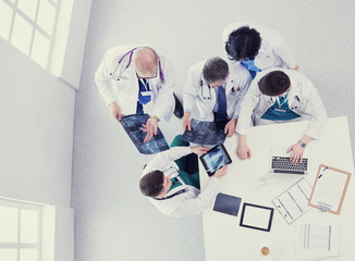 Medical team sitting and discussing at table, top view