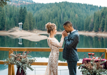 Wedding day. Stylish african groom and his pretty bride. African wedding couple emotional portrait loving bride and groom.