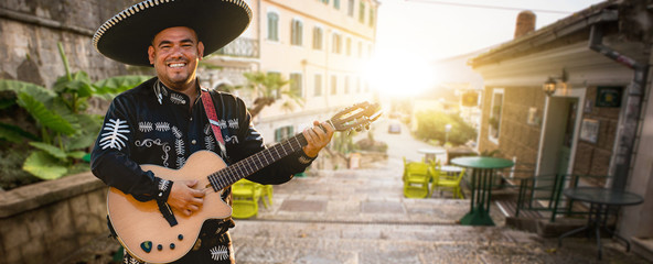 Musician plays the guitar on a city street