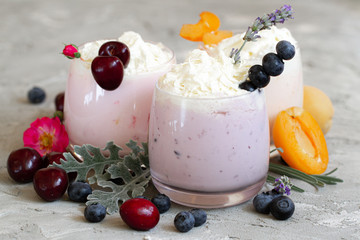 cherry, blueberry, apricot smoothie on light background. well being and weight loos concept. milkshake with fresh berries. healthy Breakfast. fruit smoothie with ingredients.
