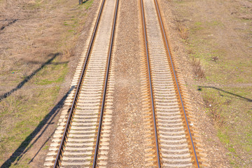Fototapeta na wymiar Old slightly rusty railroad tracks on which trains still ride.