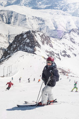 Fototapeta na wymiar Female skier enjoy in beautiful snowy alps mountain range scenic. Winter season sport and recreation travel concept