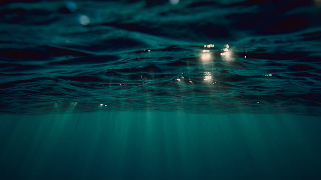 surface of the sea from underwater and sun rays