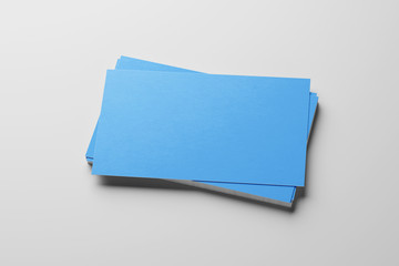 Mockup of blue business cards stack at white paper background