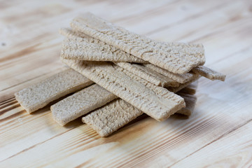 Flat lay on crisp bread slices on wooden background