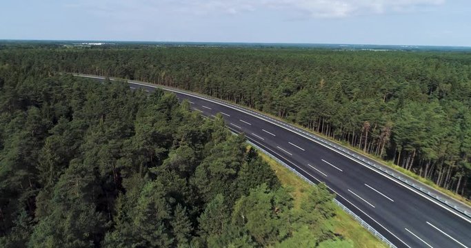 Three laned test track banking through dense forest