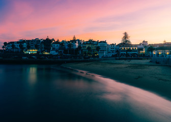 Fototapeta premium Magenta sunset overlooking the bay and historic centre of Cascais, Portugal