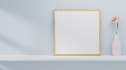 A blank picture and poster frame set on a shelf on the wall.
