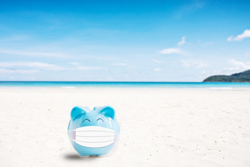 Fototapeta na wymiar summer piggy bank on the beach,abstract background to saving for holiday vacation concept.