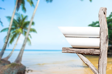 decorated mail box on  log wood over tropical beach background.