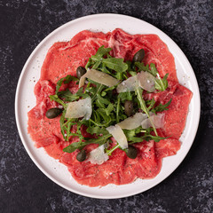 Marbled beef carpaccio with arugula, capers and parmesan cheese