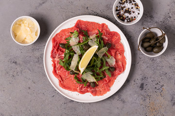Marbled beef carpaccio with arugula, capers, lemon and parmesan cheese