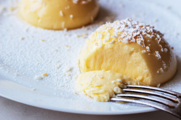 break сream pudding with vanilla on a white plate.