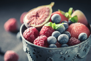 Ice cream sorbet with fresh frozen fruits on dark table