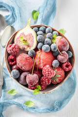 Juicy ice cream sorbet with frozen fruits on white table