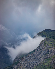 clouds hitting between the mountain beautiful landscape