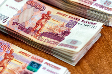 Piles of paper money five thousand rubles on  table closeup