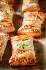 Closeup of sausage in puff pastry with thyme and sesame