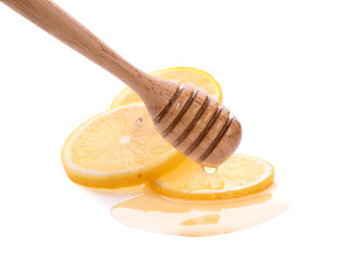 Lemon and wooden honey dipper isolated on white background