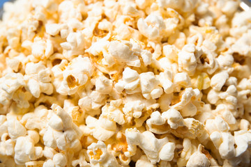 Popcorn in a plate close-up. Blue background