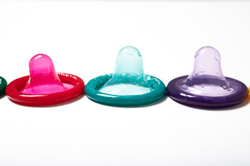 Colorful condom on white background
