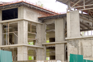 abandoned construction site behind a green fence