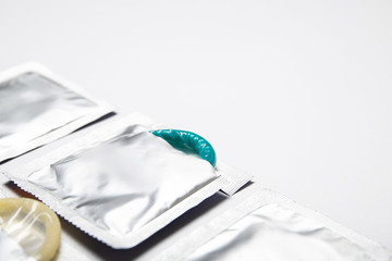 Condoms on a white background. Colored condoms. Contraception