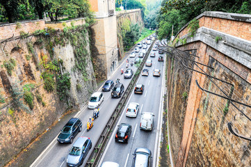 Top view of a busy street in the ancient city of Rome, Italy - Street is full of cars and scooters...
