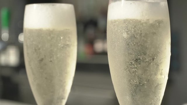 Slow Motion of bubbles in champaign glass at high end restaurent with foam on top Prosecco brut special drink fizzy wedding anniversary