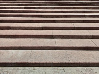 Stone staircase in an old park. Red granite steps