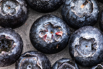 Obraz na płótnie Canvas Frozen blueberries close up view on ice.