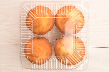 Tasty sweet muffins, close-up, on a painted wooden table.