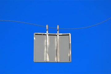 empty back side silver road sign on twisted metal wire on blue sky, security travel diversity