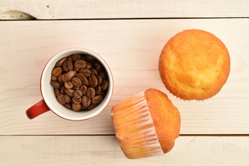 Tasty sweet muffins, close-up, on a painted wooden table.