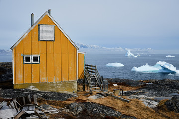 Small yellow coloured house in Greenlandic village of Alluitsup Paa