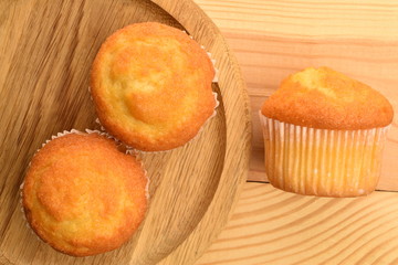 Tasty sweet muffins, close-up, on a wooden table.