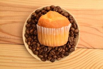 Tasty sweet muffins, close-up, on a wooden table.