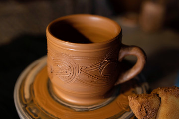 Clay Cup with a pattern in the workshop.