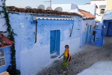 Alone woman traveling in blue city of  Chefchaouen,Morocco.