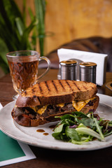 Club sandwich with cheese, salad,  meat.