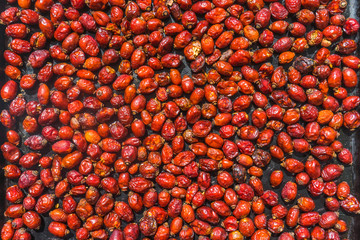 Dried rose hips on a linen background. Dog rose hips are drying. 
