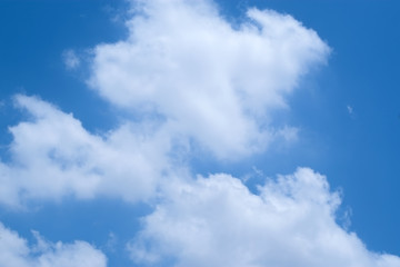 Naklejka na ściany i meble Group of white fluffy clouds and blue sky