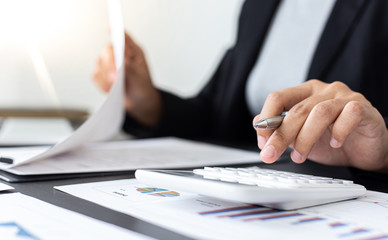 Accounting businessmen are calculating income-expenditure and analyzing real estate investment data, Financial and tax systems concept.