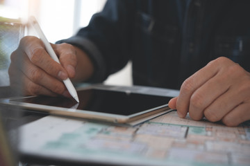 Home interior designer using stylus pen on digital tablet computer working in modern office