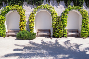 Park benches on embankment on sunny spring day. Place to relax. Montenegro, Tivat city