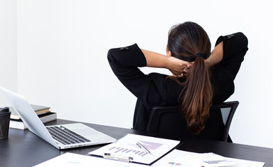 She is stressed due to the economic downturn causing migraine headaches, Financial accountants work on the analysis and summary of company revenue in real estate, Hard work and overtime work concept.