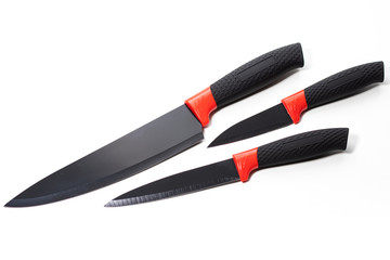 Steel kitchen knife with a black handle set isolated over the white background